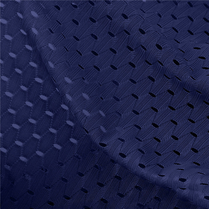 Close-up of navy blue perforated mesh fabric with a small hole pattern, softly folded 2