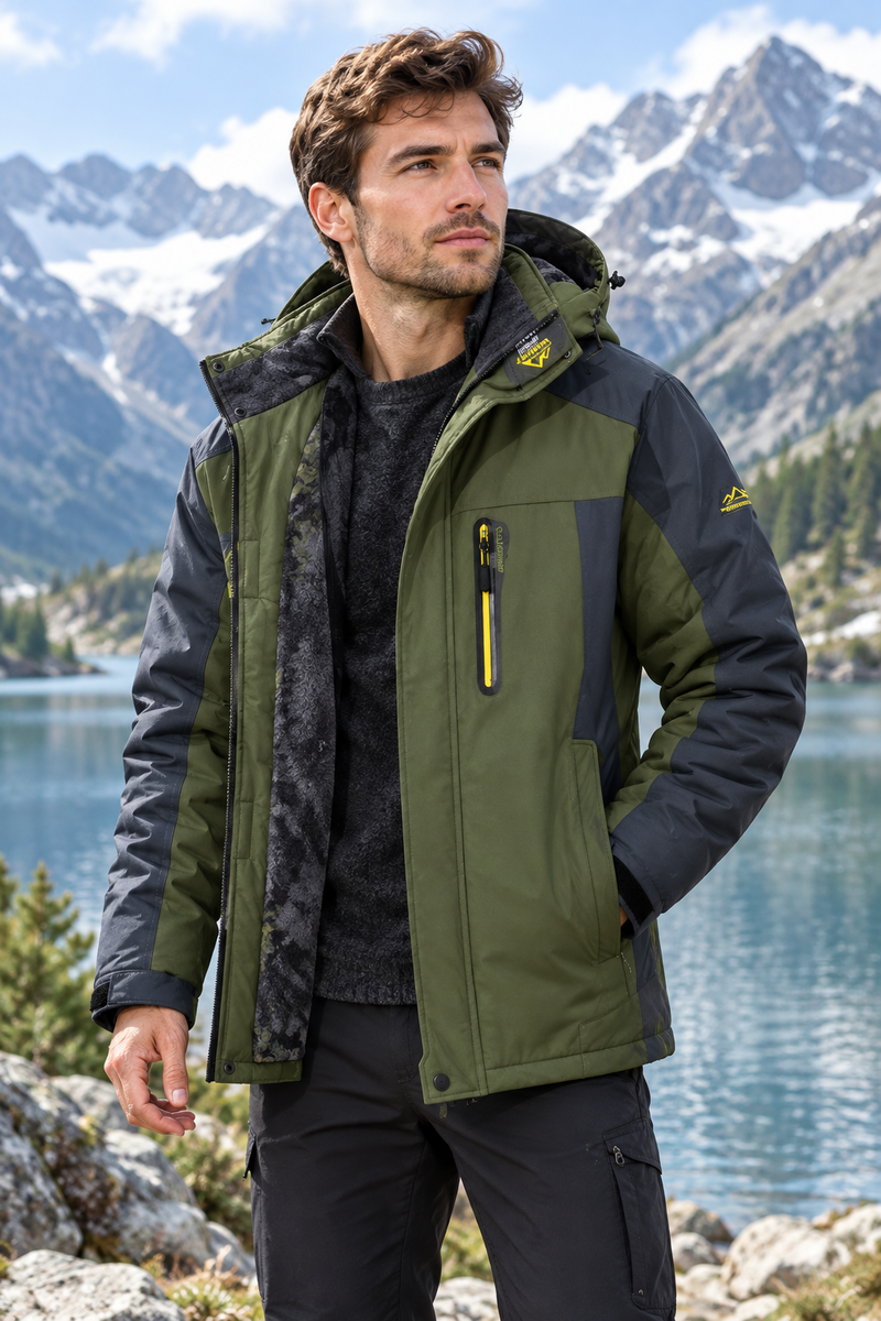 Man wearing the olive green and grey hooded jacket, unzipped, beside a mountain lake 1