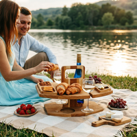 Couple sitting on a picnic blanket by a lake, sharing croissants and wine from the wooden table 1