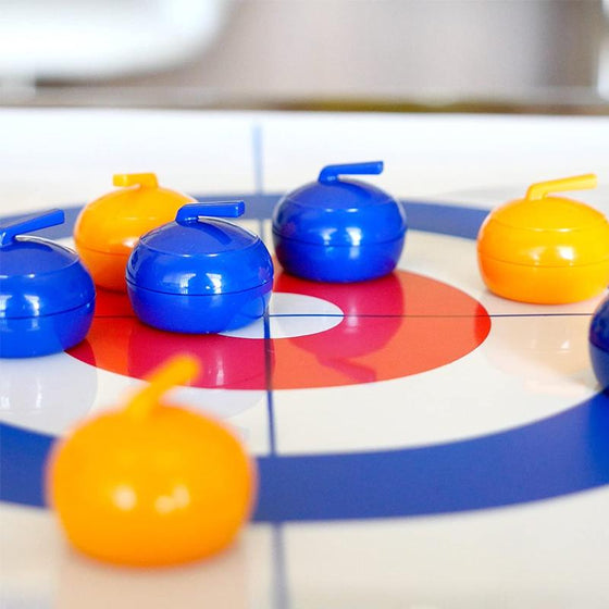 Mini table-top curling game for home use with sliding stones and magnetic sticks