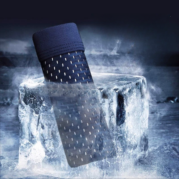 Rolled navy mesh boxer briefs sitting in a block of ice amid frosty mist 3