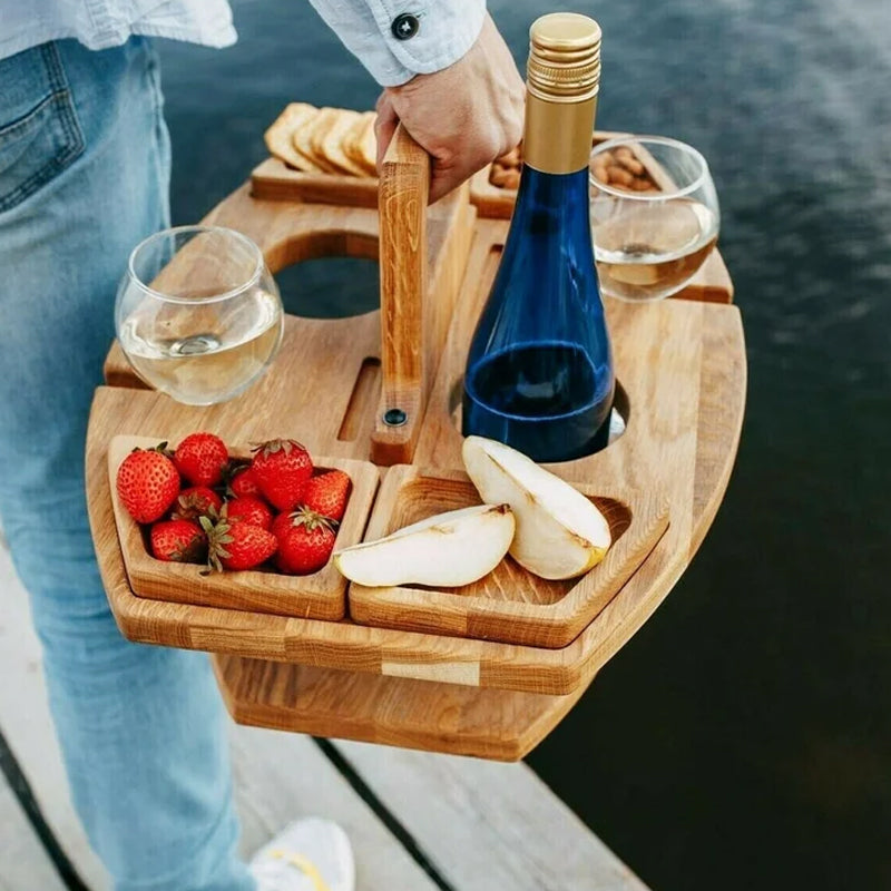 Person carrying the loaded table by its upright handle, with strawberries, pear slices, two glasses and a blue bottle 4