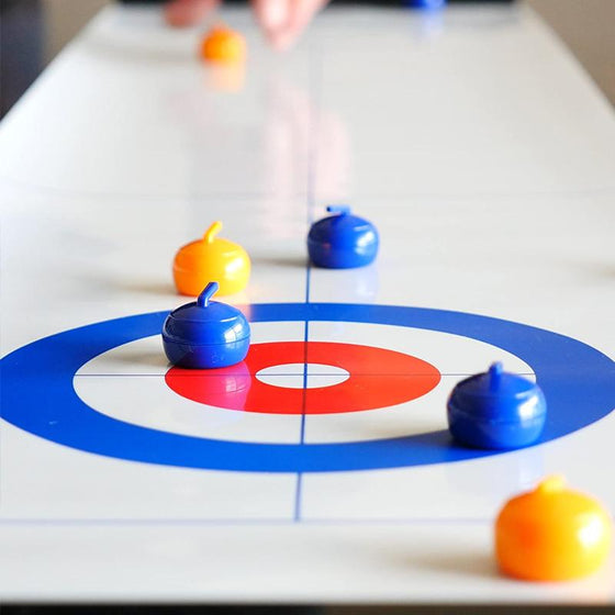 Mini table-top curling game for home use with sliding stones and magnetic sticks