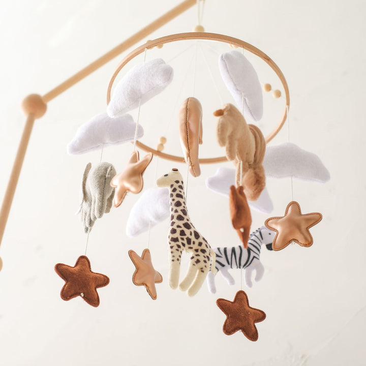 Mobile hanger with felt safari animals to stimulate babies' sensory perception.