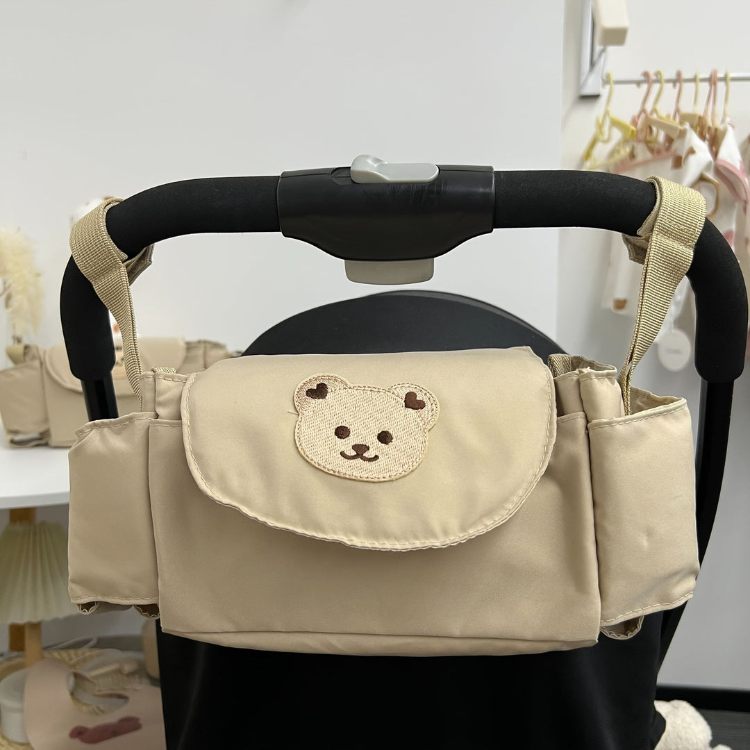 Hanging pram bag with bear motif – space-saving storage solution