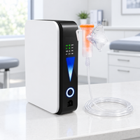 White and black slim oxygen concentrator on a clinic counter, with orange nebuliser cup, mask and coiled clear tubing 1