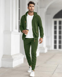Model walking along a white colonnade in the green tracksuit with a white tee, holding a coffee 19