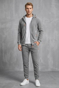 Front view of the light grey fleece-style zip-up hoodie and joggers with orange zips 10