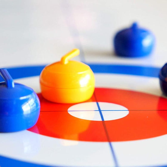 Mini table-top curling game for home use with sliding stones and magnetic sticks