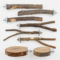 Flat lay of eight natural wooden bird perches: straight and forked branches plus two round wood slabs, each with a metal washer and wing nut. 1