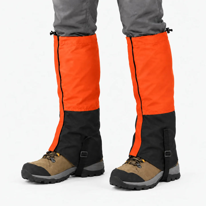 Orange and black gaiters worn over hiking boots on a white background, with side zip and instep straps 12