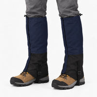 Navy blue and black gaiters worn over brown hiking boots, shown on a white background with instep straps 6