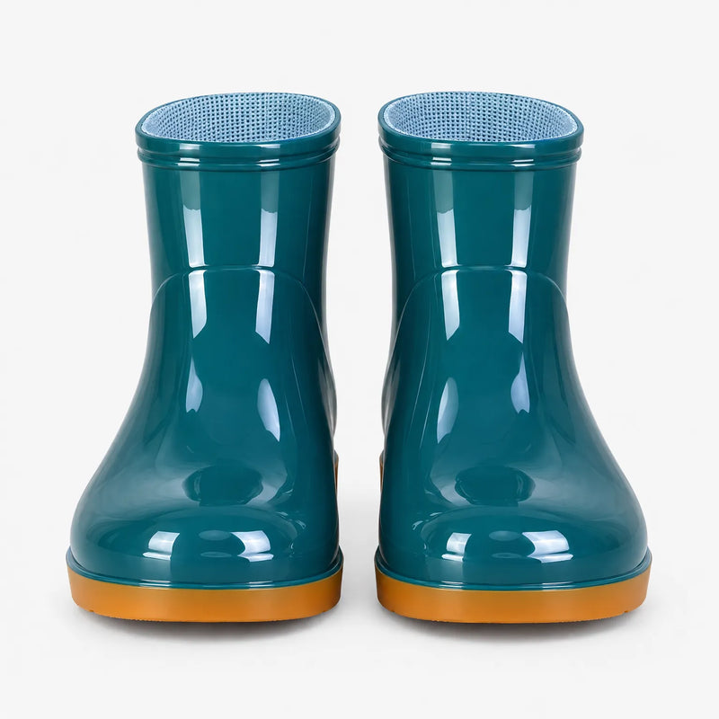 Front view of a pair of teal glossy ankle boots with orange soles and blue mesh lining. 7