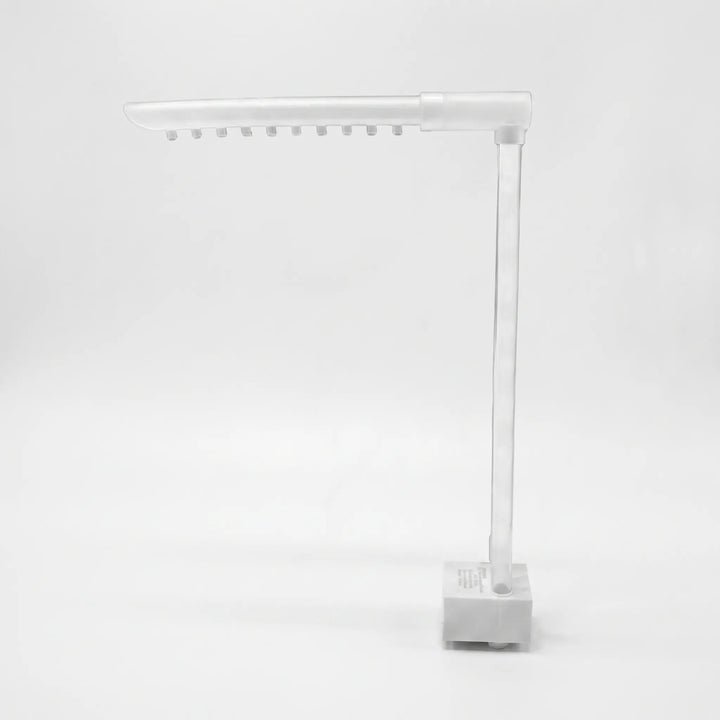 Detached white and clear water-spout assembly with a pump base, a tall clear tube and a horizontal arm with ten nozzles. 3
