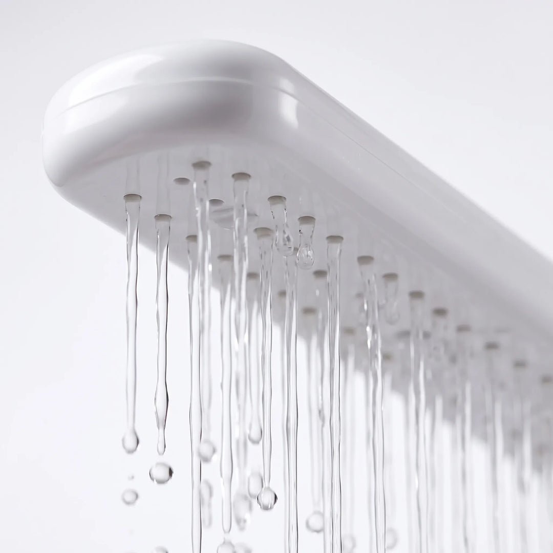 Close-up from below of the spray arm's row of small nozzles, with thin streams of water running down. 3
