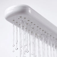 Close-up from below of the spray arm's row of small nozzles, with thin streams of water running down. 3
