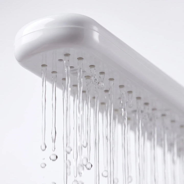 Close-up from below of the spray arm's row of small nozzles, with thin streams of water running down. 3