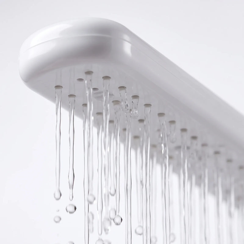 Close-up from below of the spray arm's row of small nozzles, with thin streams of water running down. 3