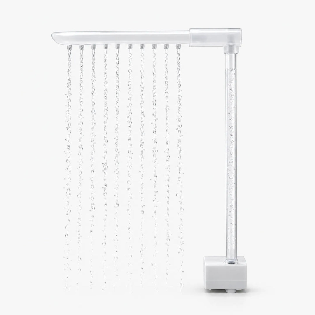 Side view of the spray arm and clear upright tube with rising bubbles, the water falling in even streams beside the pump base. 4