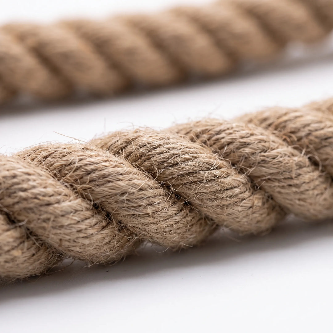 Close-up of the twisted, slightly fuzzy natural fibres of the rope, with the blurred length of rope behind. 3