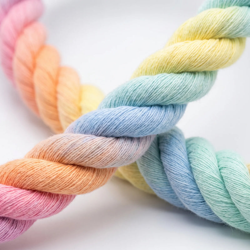 Close-up of the three-strand twisted rope, showing its soft fibres and pastel gradient of pink, orange, yellow, blue and green. 3