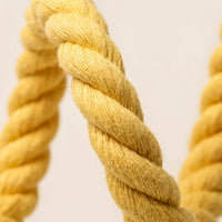 Close-up of the yellow rope's thick twisted strands, showing the soft cotton fibres and texture. 3