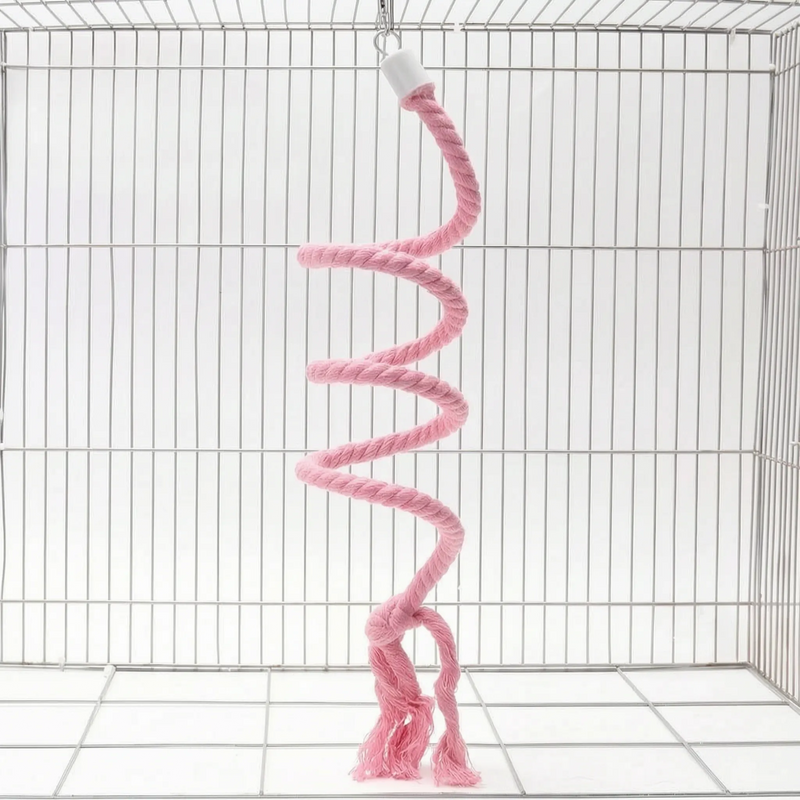 Pink version of the spiral rope perch hanging in a wire cage by a small hook, with a knotted, frayed end. 6