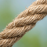 Close-up of the thick twisted natural fibre rope, showing its rough, fibrous texture against a soft green and blue background. 4