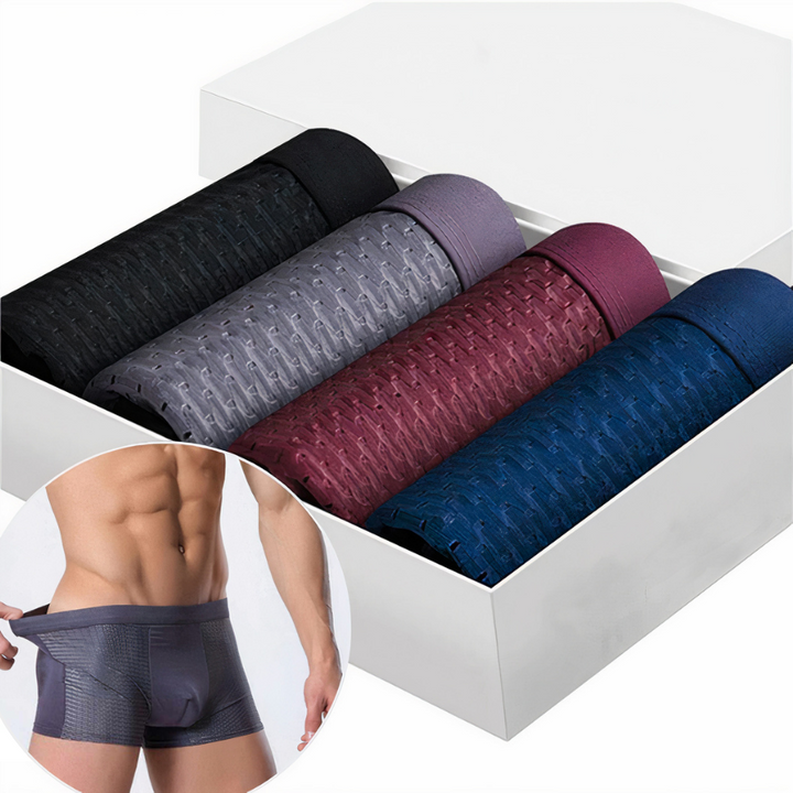 Four rolled mesh boxer shorts in black, grey, burgundy and navy in a white box, with a model wearing a pair inset 1