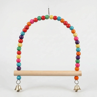 Wider version of the swing with a longer arch of more beads and a longer wooden perch, two bells hanging below. 6