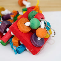 Close-up of the red wooden top block with threaded beads, discs, white cotton rope and the metal clip. 4