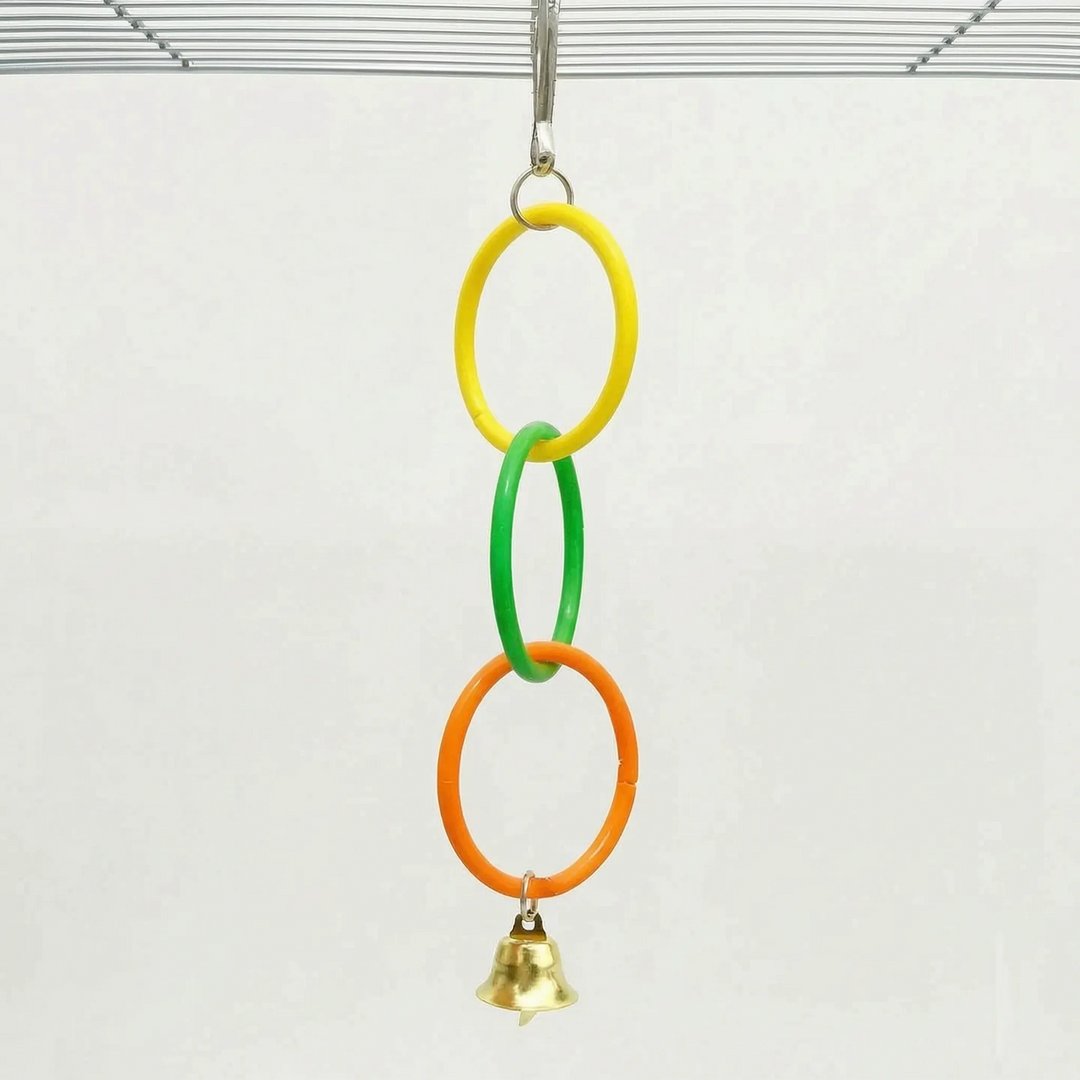 Shorter version of the toy with three linked rings in yellow, green and orange and a gold bell, hung from a cage roof. 5