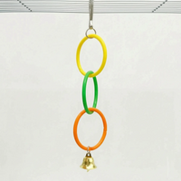 Shorter version of the toy with three linked rings in yellow, green and orange and a gold bell, hung from a cage roof. 5