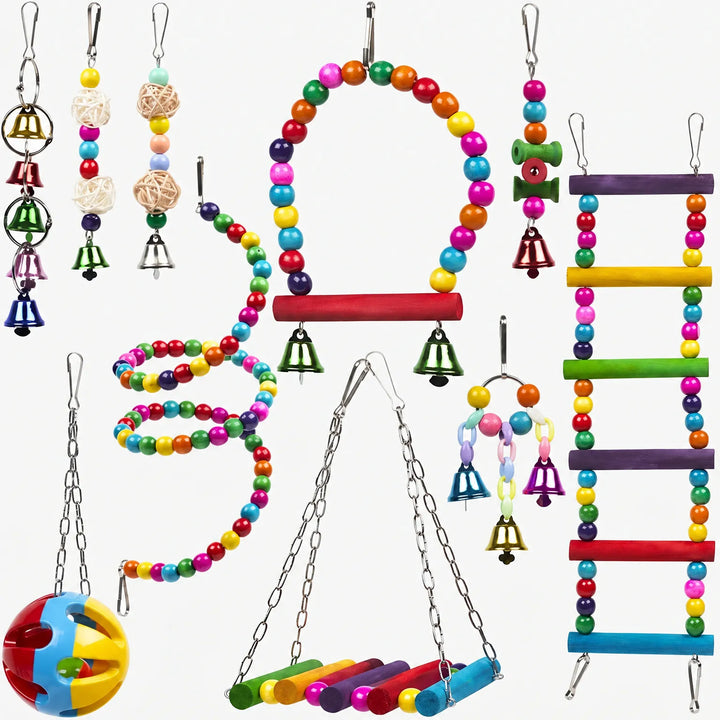 Ten colourful hanging bird toys laid out on white: beaded swing, spiral, ladder, bells, rattan balls, a perch swing and a plastic ball. 1