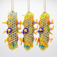 Three hanging woven cane tubes stuffed with shredded coloured paper, decorated with flower-shaped and round beads on knotted strips. 3