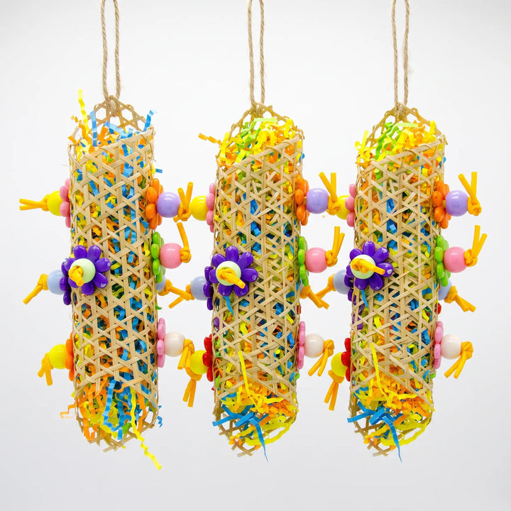 Three hanging woven cane tubes stuffed with shredded coloured paper, decorated with flower-shaped and round beads on knotted strips. 3