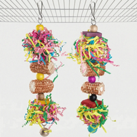 Two hanging shredding toys with coloured paper strips, wooden beads and blocks, corn cob pieces and a bell, clipped to a cage. 5