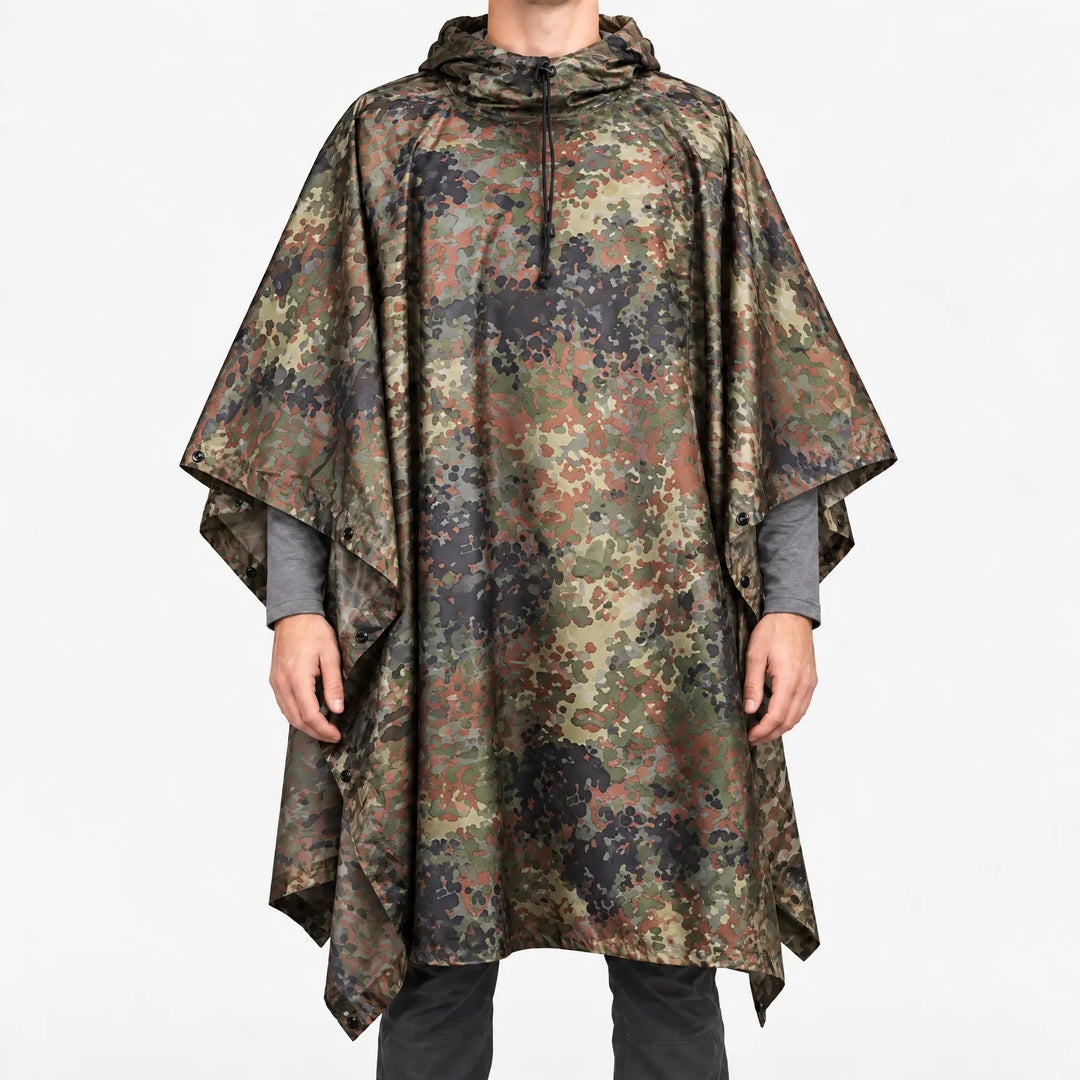 Front view of the hooded poncho in a speckled green, brown and black flecked camouflage pattern on a model. 13