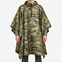 Front view of the hooded poncho in a green, brown and tan multi-terrain camouflage pattern, worn over a grey long-sleeve shirt. 7