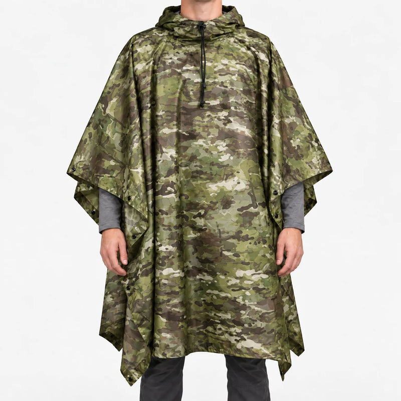Front view of the hooded poncho in a green, brown and tan multi-terrain camouflage pattern, worn over a grey long-sleeve shirt. 7