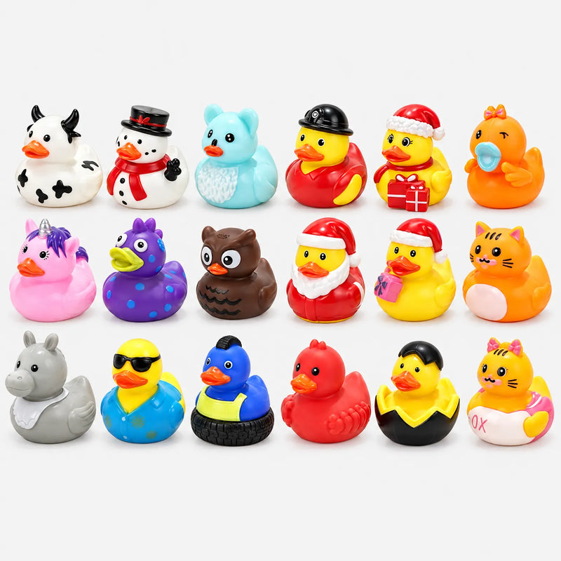 Flat lay of eighteen rubber ducks in different costumes, including cow, snowman, Santa, owl, unicorn and cat designs, on a plain background. 3