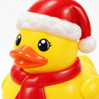 Close-up of a yellow rubber duck wearing a red Santa hat and red scarf, showing its glossy finish and painted eyes. 4