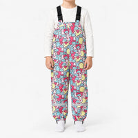 Child in dungarees with a busy pattern of pastel blue and pink bunnies, hearts and clouds, with buckled straps and reflective ankle bands. 15