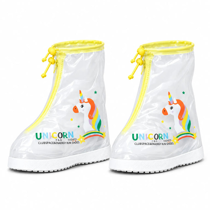 Pair of clear shoe covers with yellow trim and drawstring toggles, a rainbow unicorn print and white non-slip soles on white. 7