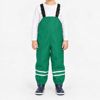 Child facing front in green waterproof dungarees with black adjustable straps, reflective ankle stripes and navy boots, white background. 10