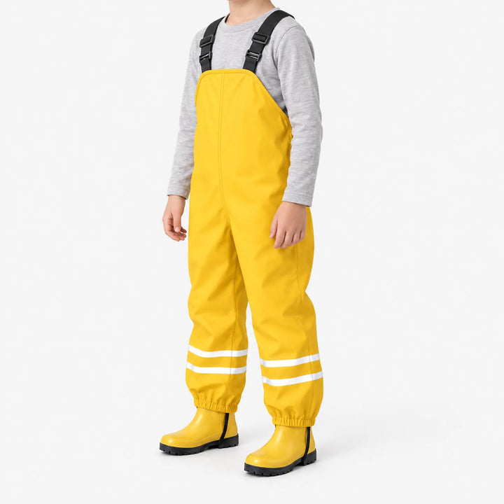 Child in yellow waterproof dungarees with yellow rubber boots, shown at a three-quarter angle with reflective stripes on the lower legs. 5