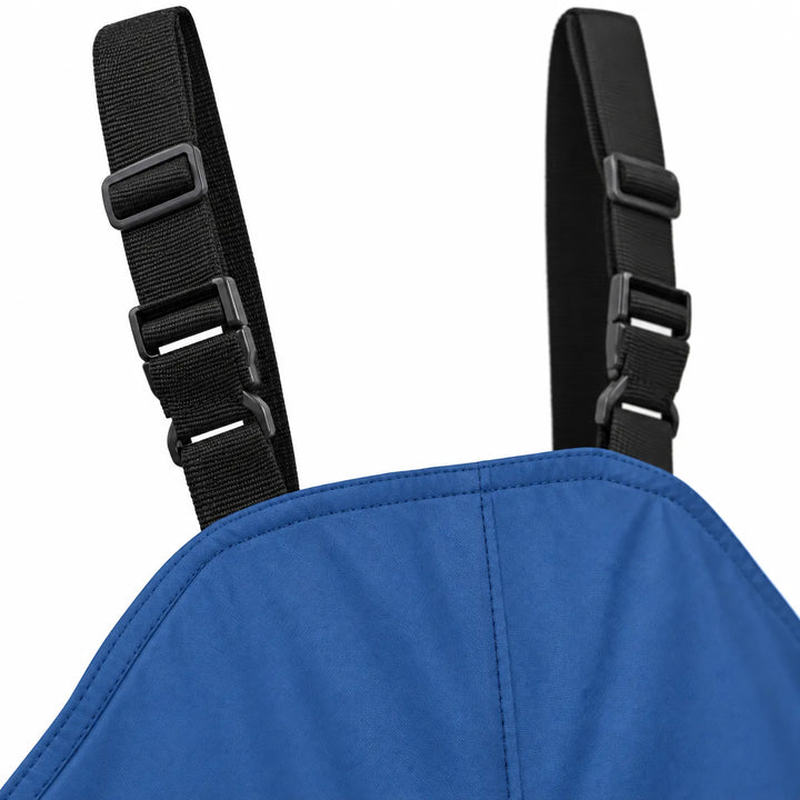Close-up of the black adjustable shoulder straps with plastic buckles and sliders attached to the chest bib of blue dungarees. 6