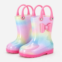 Pair of pastel rainbow wellies with two pink carry handles each, a pink bow and a pink sole. 2