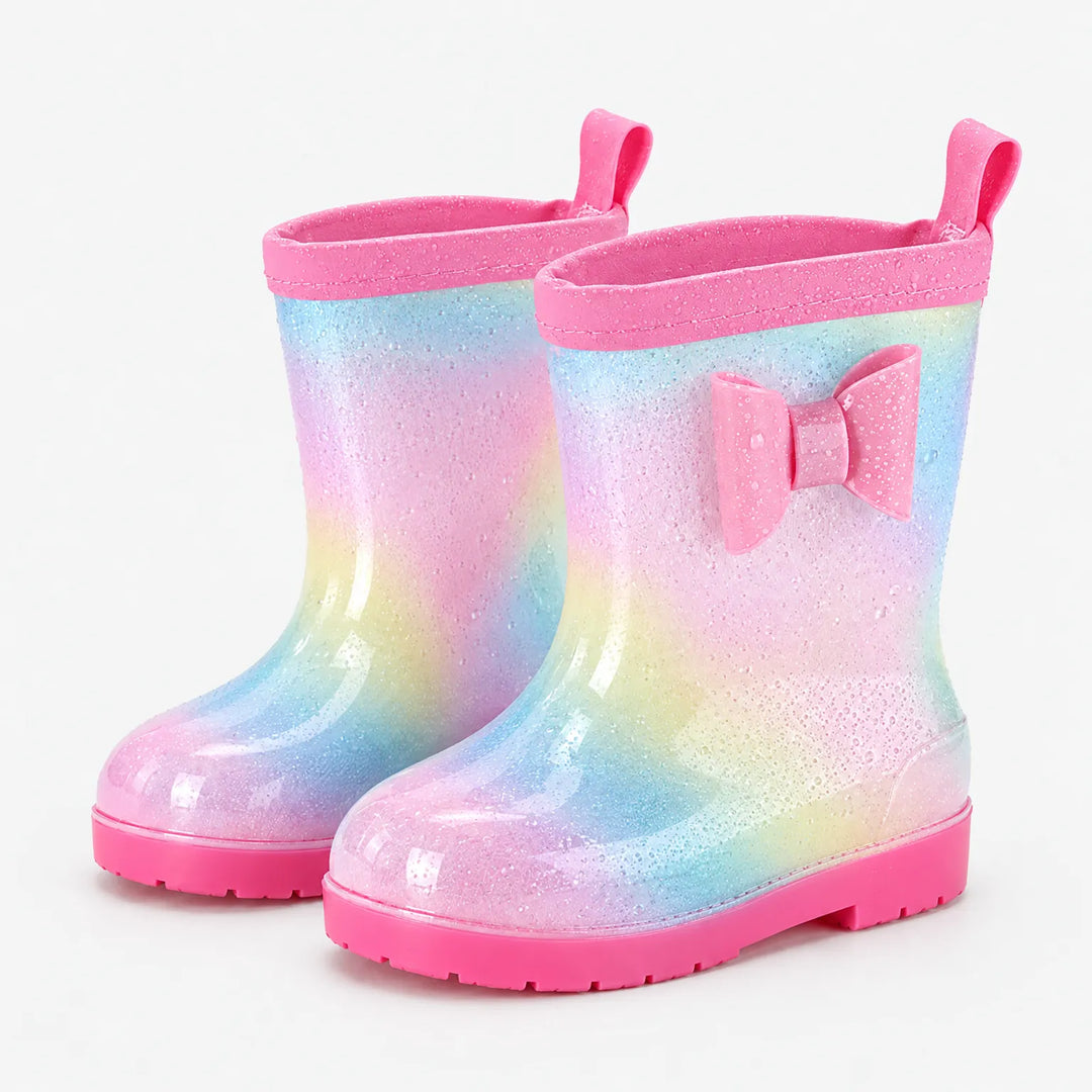 Pair of glittery rainbow wellies with water droplets on the surface, a pink bow, pull tabs and pink soles. 7
