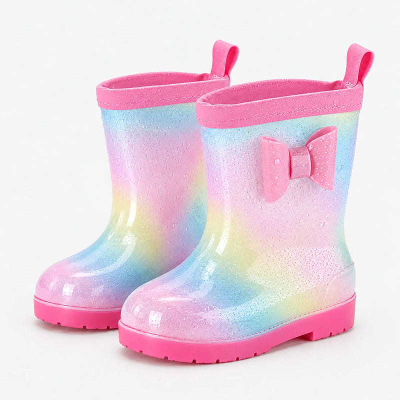 Pair of glittery rainbow wellies with water droplets on the surface, a pink bow, pull tabs and pink soles. 7